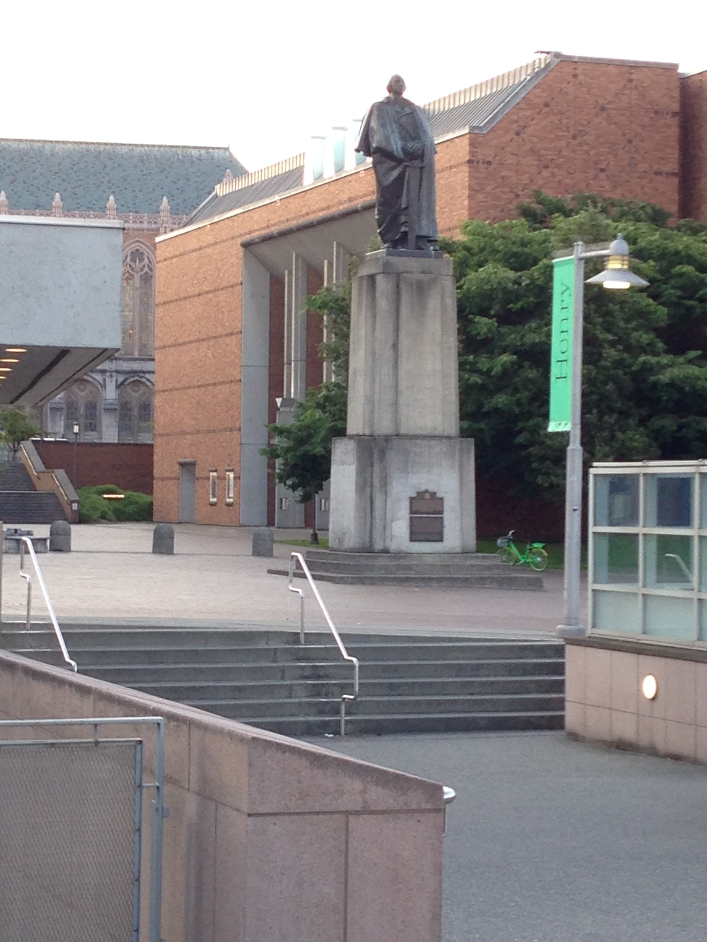 A bronze figure indicating the way down the stairs away from the university campus and toward Smith Hall, the university's student loan center.
